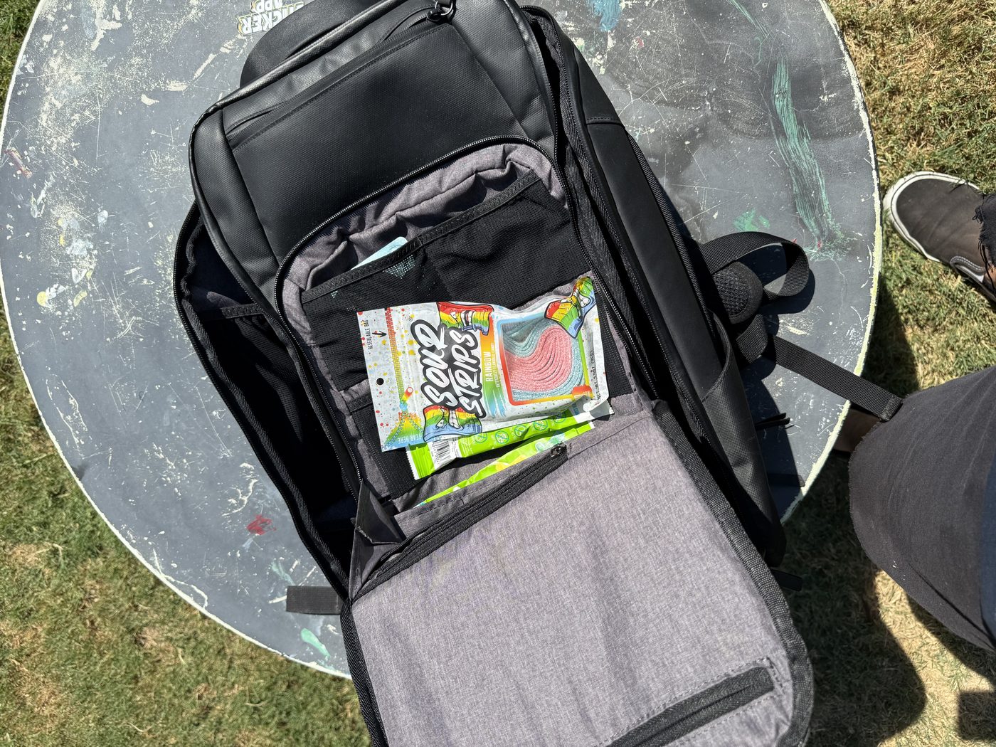 The organizer pocket, currently holding my kid's Sour Strips, telling you whose bag this really is