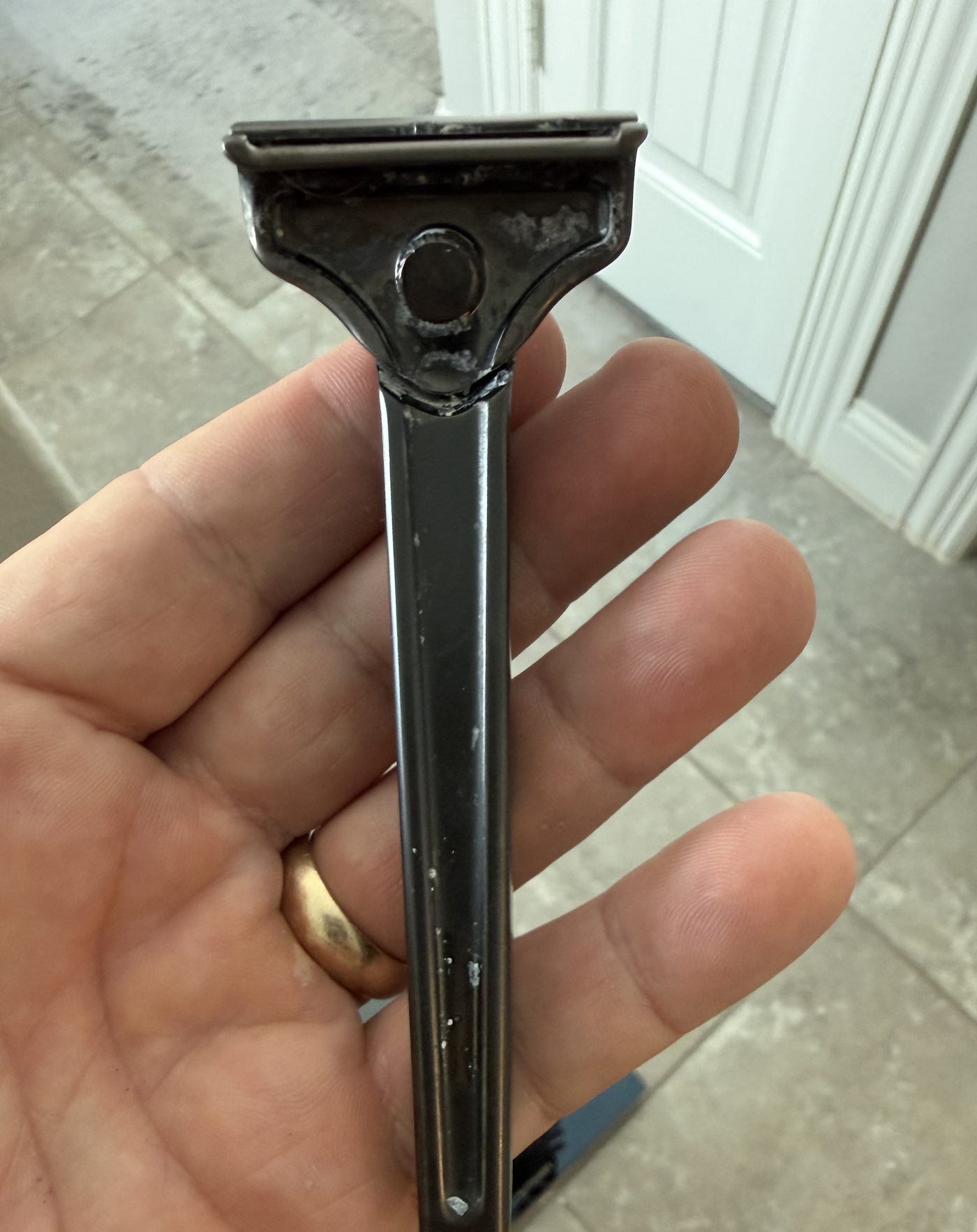 The razor in hand, solid metal from head to handle