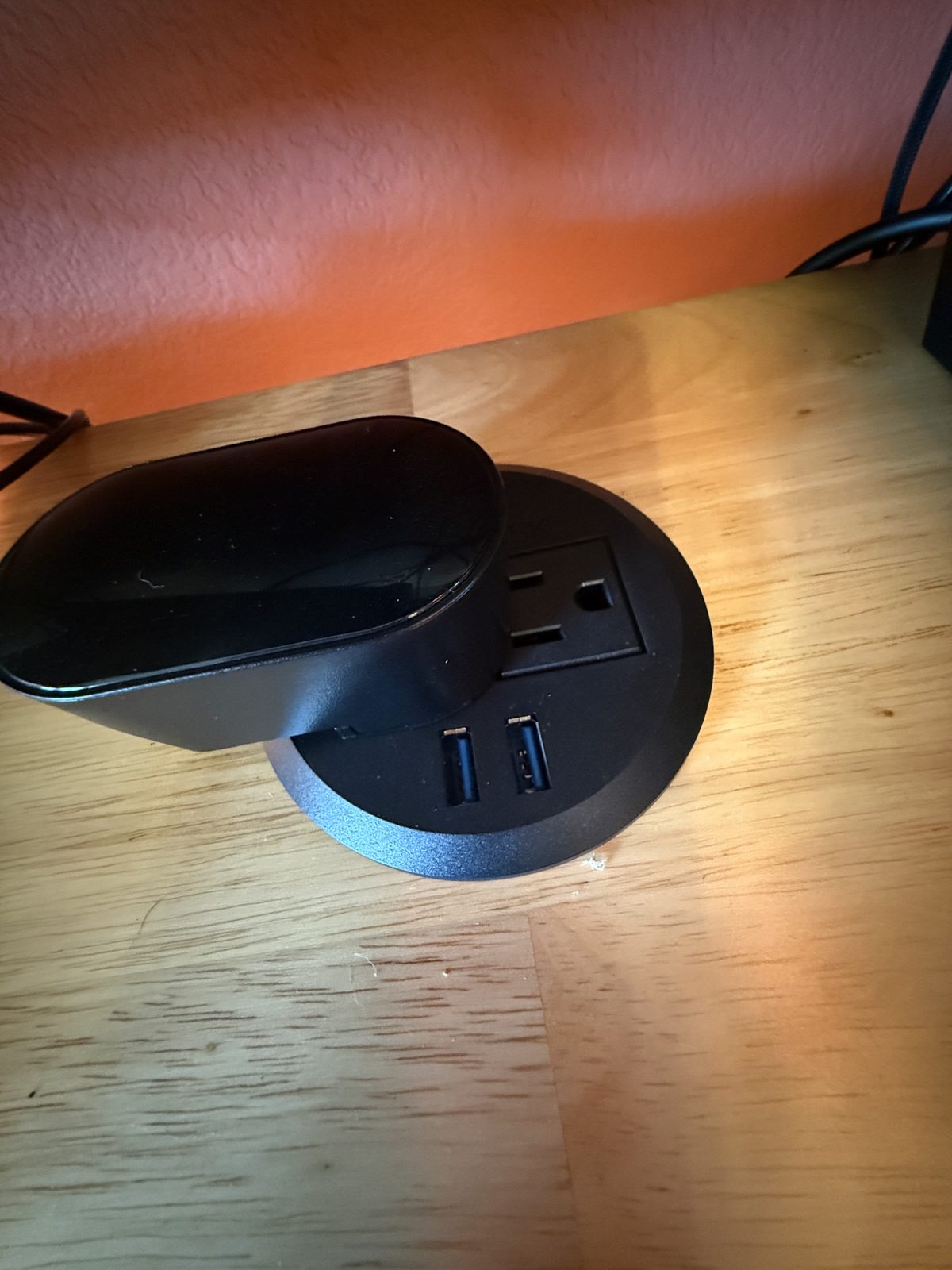 A power inlay in the desktop with an outlet and USB ports
