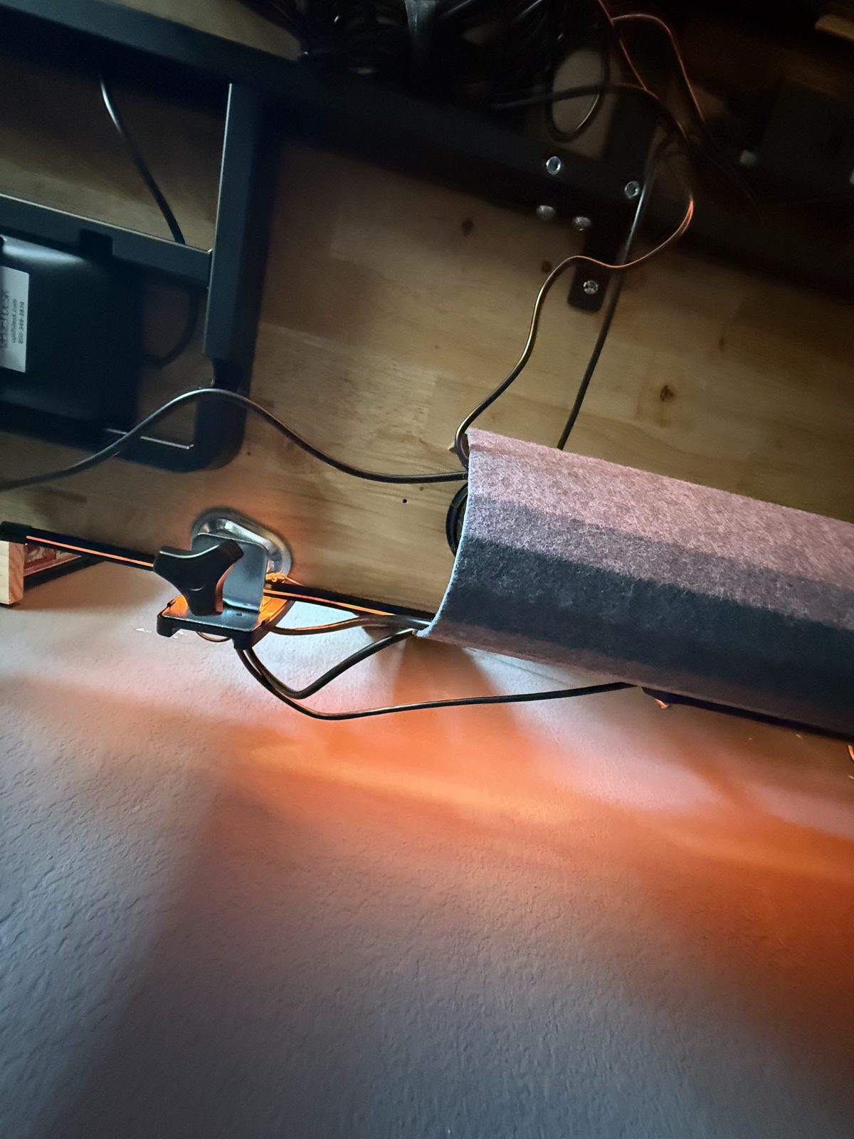 The single wrapped cable running down the desk leg in the concealer