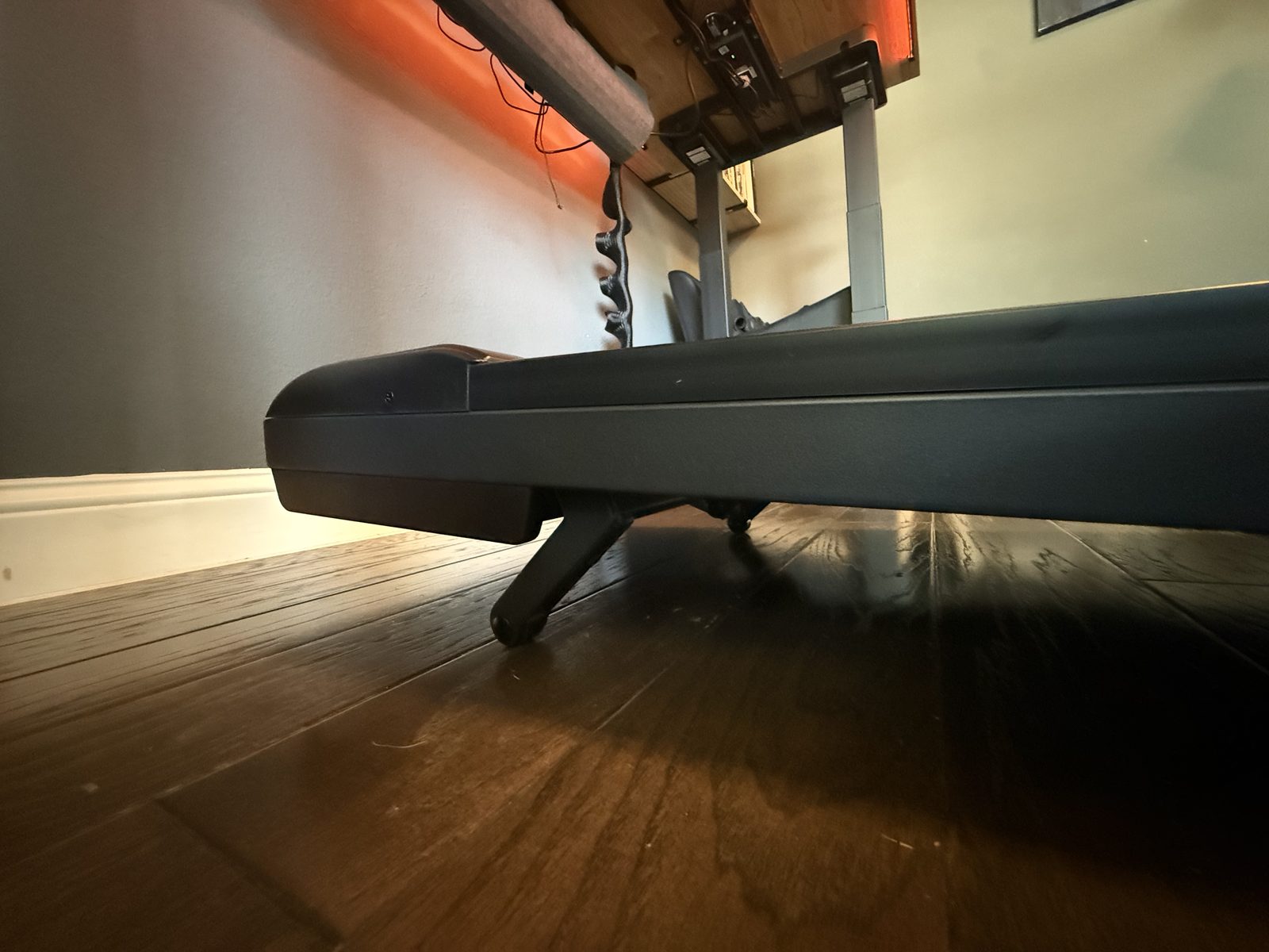 The UPLIFT walking pad stowed under the desk