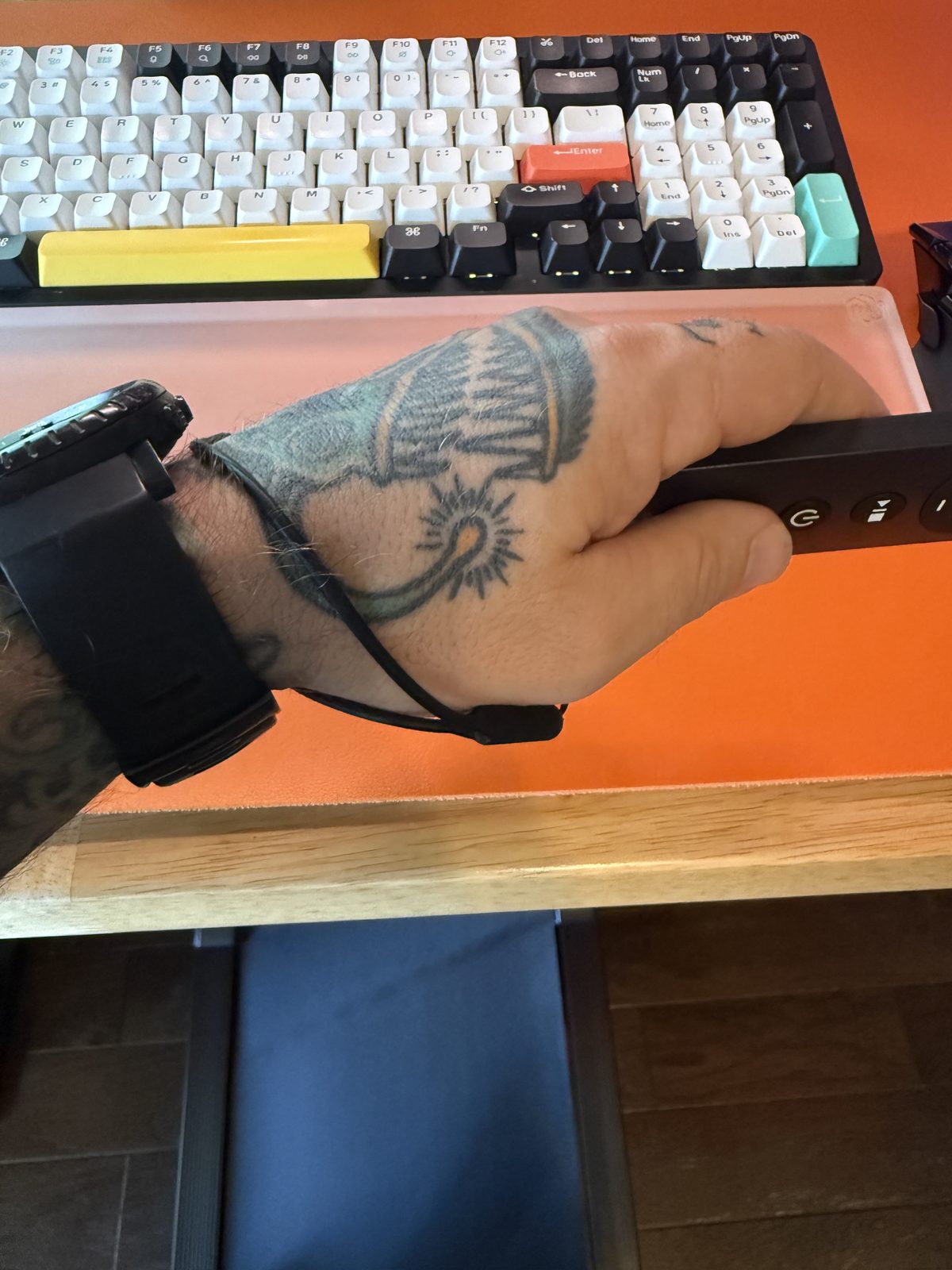 The rubber remote riding on a wrist lanyard while walking