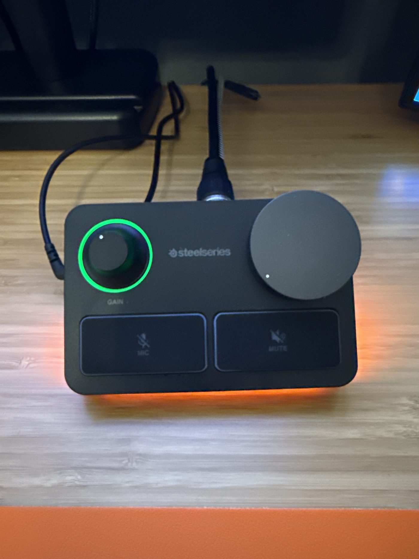 The stream mixer: one knob for gain, one for volume, glowing like it knows it's the cockpit